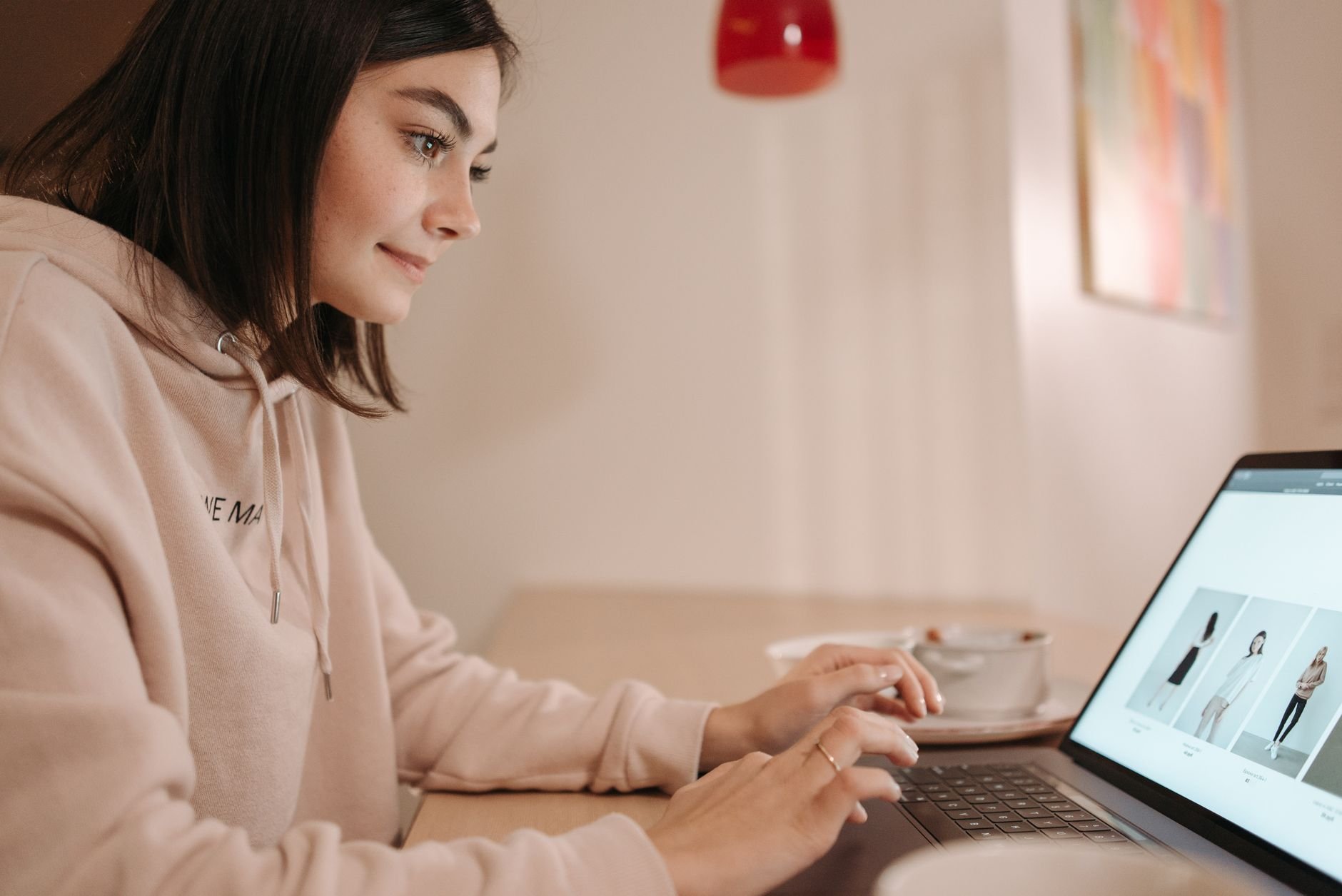 Woman browsing an online fashion store on a laptop at home
